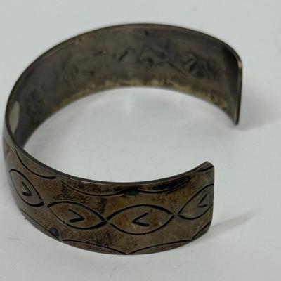 Sale Photo Thumbnail #499: Bracelet has markings inside that are faint and could not be identified, but the bracelet has the look and feel of a vintage silver bracelet.