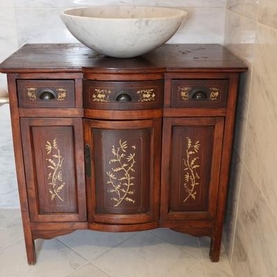 Wood Cabinet Vanity with Marble Vessel Sink and Gold Floral Detail