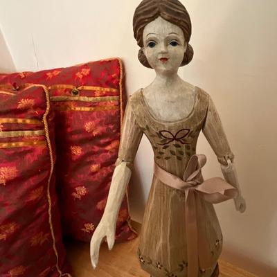 Wooden carved doll, very old children’s book, pillows