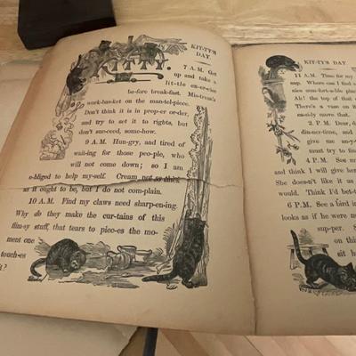 Wooden carved doll, very old children’s book, pillows
