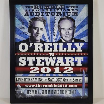 LOT 87: Autographed Framed "The Rumble in the Air-Conditioned Auditorium" Poster Autographed by Jon Stewart and Bill O'Reilly