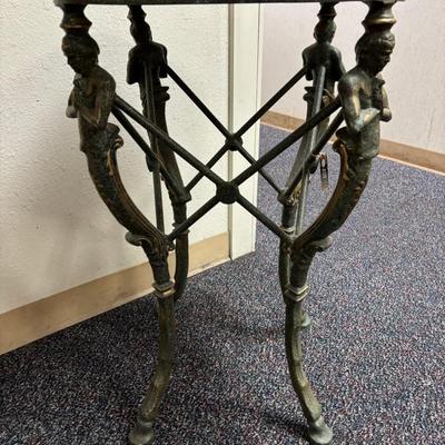 Sale Photo Thumbnail #637: Heavy Metal stand with mythological figures
Black marble separate top, needs polish
19" wide x 19" deep x 31.25 " tall 
Retail  is $650 - $895