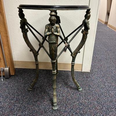 Sale Photo Thumbnail #636: Heavy Metal stand with mythological figures
Black marble separate top, needs polish
19" wide x 19" deep x 31.25 " tall 
Retail  is $650 - $895