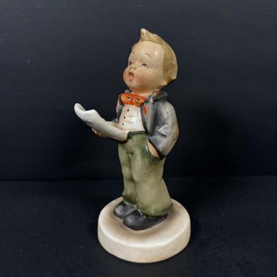 LOT 99: Set of 2 Hummels: Blessed Event & School Boy along with a Napco The Singer Figure