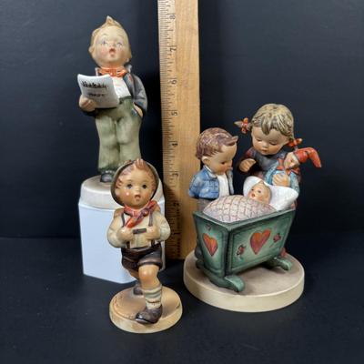 LOT 99: Set of 2 Hummels: Blessed Event & School Boy along with a Napco The Singer Figure
