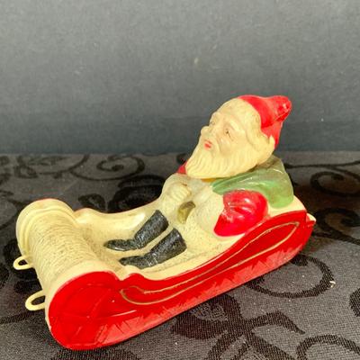 LOT 147: Assorted Collection of Vintage Holiday Decor Including Knee Huggers, Celluloid Santa in Sled, Paper Santa In Chimney, Dan Dee...
