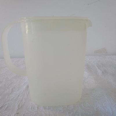 Sale Photo Thumbnail #625: 2 trivets, 1 Rubbermaid jug, 1 Tupperware pitcher, 1 small jar with lid, 1 multipurpose plastic caddy