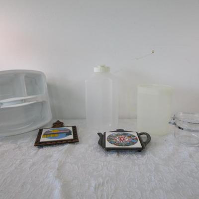 Sale Photo Thumbnail #618: 2 trivets, 1 Rubbermaid jug, 1 Tupperware pitcher, 1 small jar with lid, 1 multipurpose plastic caddy