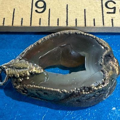 Agate geode pendant sparkling druzy crystals within its cavity and edge and bail