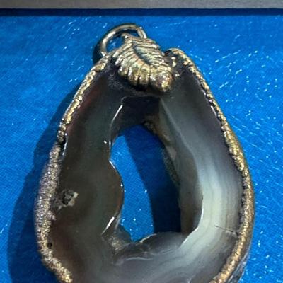 Agate geode pendant sparkling druzy crystals within its cavity and edge and bail