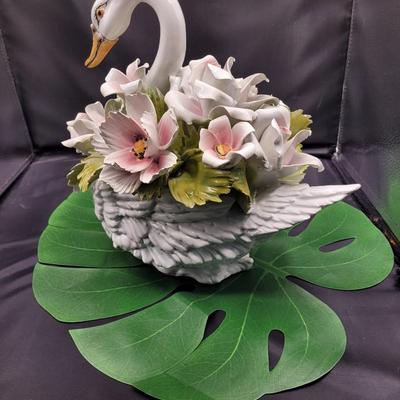Sale Photo Thumbnail #659: 12.5 x 12.5 inches, #G706
Heavily flowered swan. There is damage to one flower , one petal is chipped off.  
Very beautiful piece of porcelain 
Fair condition
Retails $125 to $425