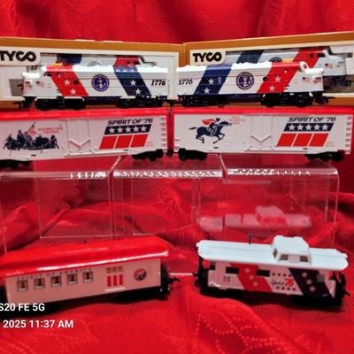Sale Photo Thumbnail #660: HO Scale train set, Bicenntennial 
4 engines, 2 box cars, passenger car and caboose.
Most are in original boxes.  
Retails $149 to $275