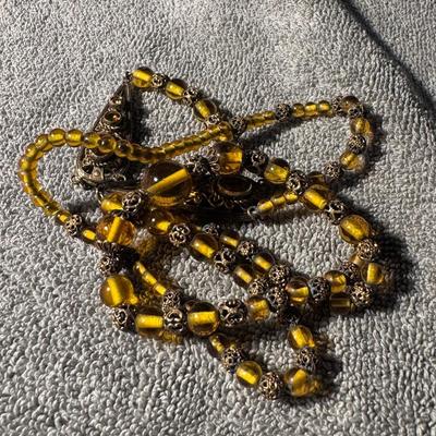 ART DECO amber-colored bead necklace, featuring ornate metal accents.