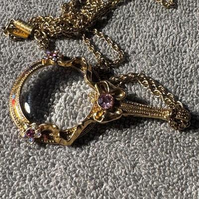 ART DECO amber-colored bead necklace, featuring ornate metal accents.