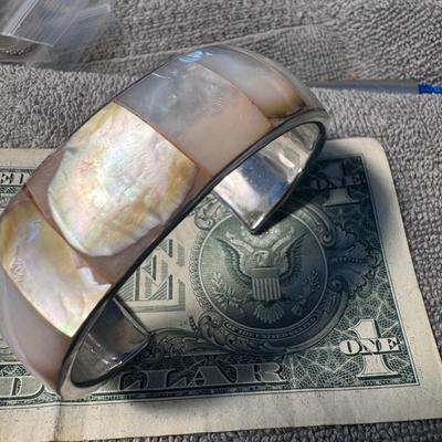 Bangle Bracelet , mother-of-pearl or abalone shell set into a metal base.