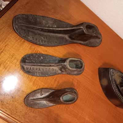 CAST IRON SHOE FORMS AND A CAST CLOTHES IRON