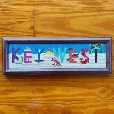 Sale Photo Thumbnail #65: Needle point is framed and measures 18.25" x 6.25" with table lamp with lamp shade that does not sit on straight measuring 14"H