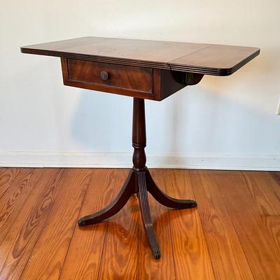 Sale Photo Thumbnail #102: Mahogany with burled walnut drawer with brass clawed feet.
Measure 17.5"W x 15.5"D x 27.5"H, leafs up is 29"L