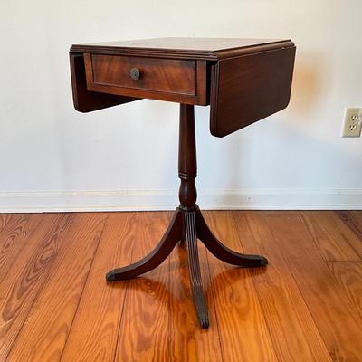Sale Photo Thumbnail #101: Mahogany with burled walnut drawer with brass clawed feet.
Measure 17.5"W x 15.5"D x 27.5"H, leafs up is 29"L