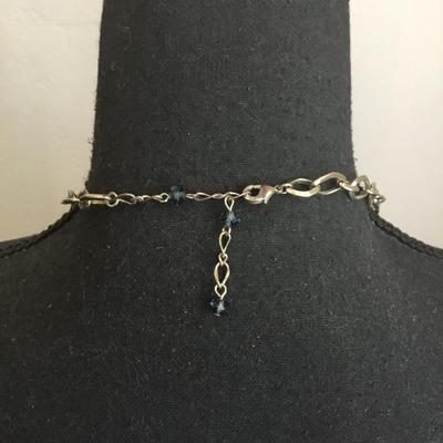 Very nice gold toned, chain-link necklace with absolutely beautiful blue ocean deep blue crystals necklace very nice very beautiful. Nice...