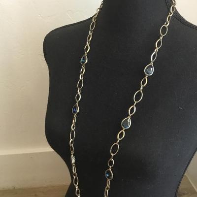 Very nice gold toned, chain-link necklace with absolutely beautiful blue ocean deep blue crystals necklace very nice very beautiful. Nice...