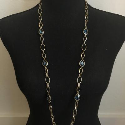 Very nice gold toned, chain-link necklace with absolutely beautiful blue ocean deep blue crystals necklace very nice very beautiful. Nice...
