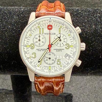 Sale Photo Thumbnail #280: With leather band. White face with 3 inset dials, luminous hands and numbers and a red sweep second hand. Date window at the 4 position. Not running, most likely needs a new battery.