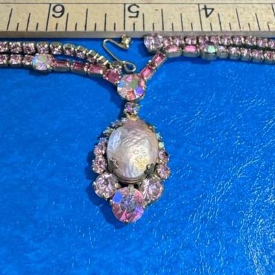 WEISS necklace featuring a central faux baroque pearl surrounded by pink and iridescent rhinestones,