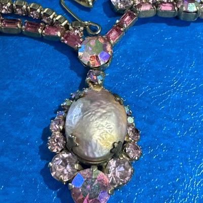 WEISS necklace featuring a central faux baroque pearl surrounded by pink and iridescent rhinestones,