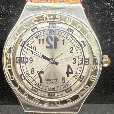 Sale Photo Thumbnail #296: Larger numbers 12, 7, and 7 are printed backwards on the dial.  Silver tone case with brown leather band. Not running, most likely needs a new battery.