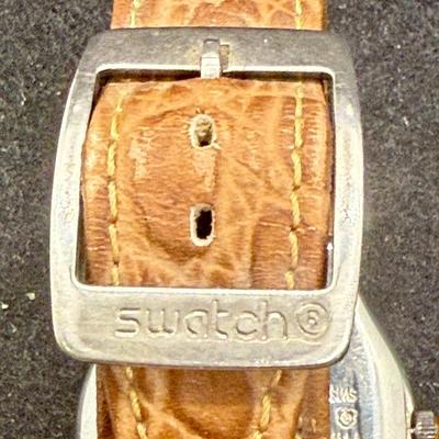 Sale Photo Thumbnail #299: Larger numbers 12, 7, and 7 are printed backwards on the dial.  Silver tone case with brown leather band. Not running, most likely needs a new battery.