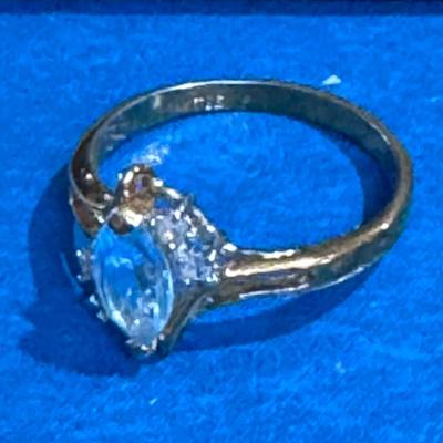 Ring featuring a prominent aquamarine gemstone.
