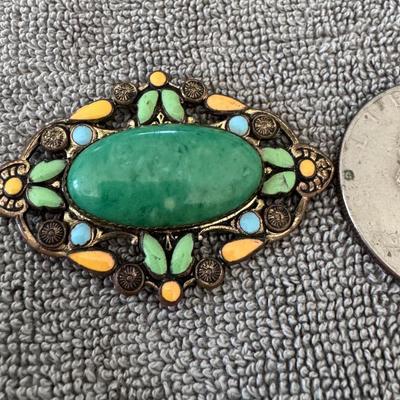 NEIGER BROTHERS - Art Nouveau style brooch featuring a central oval green cabochon stone.