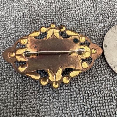 NEIGER BROTHERS - Art Nouveau style brooch featuring a central oval green cabochon stone.
