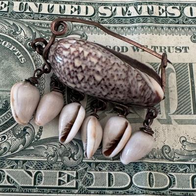 Shell jewelry pendant featuring several shells,