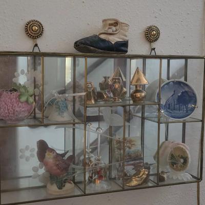 Decorative glass display includes collectibles
