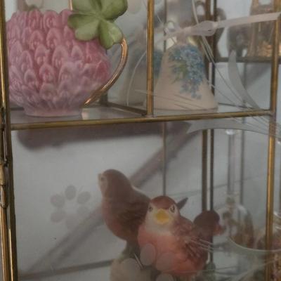 Decorative glass display includes collectibles