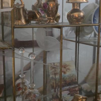Decorative glass display includes collectibles