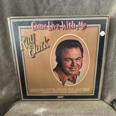 Sale Photo Thumbnail #266: "Come Live With Me" by Roy Clark.
Additional information about the album includes:
Artist: Roy Clark, a country music artist and host of the TV show Hee Haw.
Release Year: 1973.
Label: Dot Records.
Format: Originally released as a 12" 33 1/3 RPM LP vinyl 