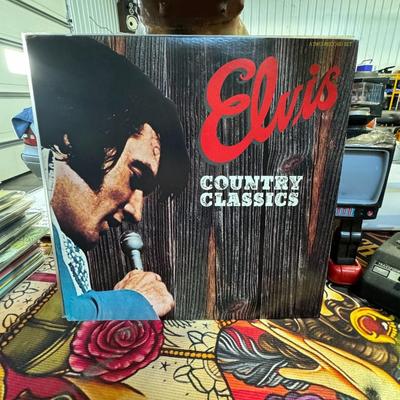 Sale Photo Thumbnail #176: "Elvis Country Classics," a double LP vinyl record set by Elvis Presley. 
Here's more information about this album:
Artist and Title: Elvis Presley - Country Classics.
Format and Label: It's a double LP (long-playing) vinyl record set released by RCA Reco