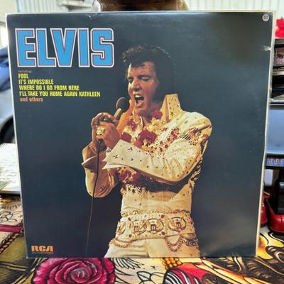 Sale Photo Thumbnail #86: "Elvis," released in 1973, features Elvis Presley. 
Additional details about the album include:
Release Information: The album was released on RCA Records in 1973 under the catalog number APL1-0283.
Track Listing: The album includes songs such as "Fool," 