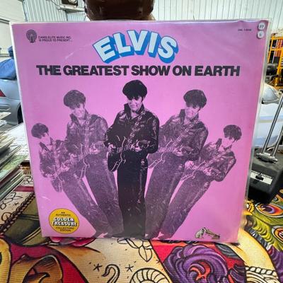 Sale Photo Thumbnail #117: Elvis Presley's "The Greatest Show On Earth" vinyl LP.
Here's some information about this record:
Artist: Elvis Presley.
Album Title: The Greatest Show On Earth.
Release Information: It's an LP (long play) vinyl record, released by RCA Special Products, a