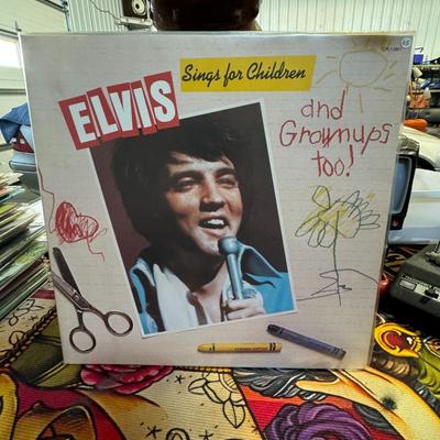 Sale Photo Thumbnail #190: "Elvis Sings for Children and Grownups Too!" by Elvis Presley. 
Additional details about the album include:
Release and Purpose: RCA Records released this compilation album in 1978, after Elvis Presley's death in 1977. It features songs for both children 