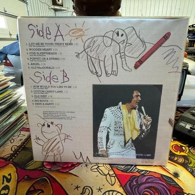 Sale Photo Thumbnail #191: "Elvis Sings for Children and Grownups Too!" by Elvis Presley. 
Additional details about the album include:
Release and Purpose: RCA Records released this compilation album in 1978, after Elvis Presley's death in 1977. It features songs for both children 