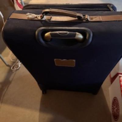 TOMMY HILFIGER AND A 2ND SUITCASE BOTH ON 4 WHEELS AND A LUGGAGE RACK