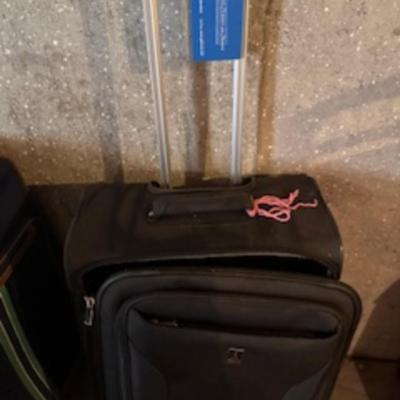 TOMMY HILFIGER AND A 2ND SUITCASE BOTH ON 4 WHEELS AND A LUGGAGE RACK