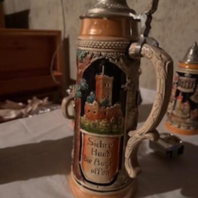 BEER STEINS, SWISS GIRL FIGURINE AND A CARVED CANDLE