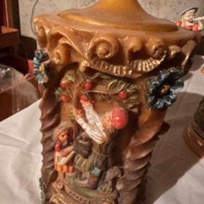 BEER STEINS, SWISS GIRL FIGURINE AND A CARVED CANDLE