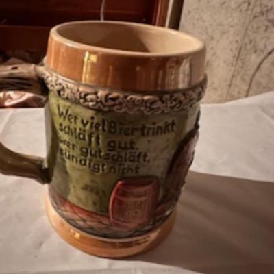 BEER STEINS, SWISS GIRL FIGURINE AND A CARVED CANDLE