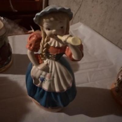 BEER STEINS, SWISS GIRL FIGURINE AND A CARVED CANDLE